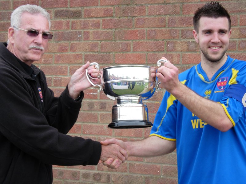 Hardwicke captain Ben Wood, accepts the trophy from league Chairman Bob Stewart