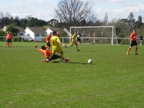 Ken Malala gets a tackle in for Henbury