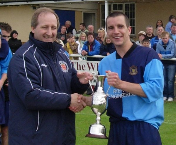 Kings Stanley captain Martin McDermott receives the Trophy from GFA Chief Executive David Neale