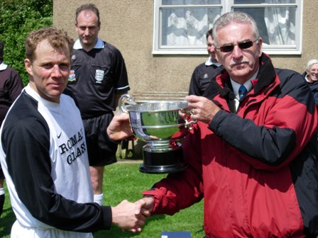 League Chairman Bob Stewart presents the Championship Trophy